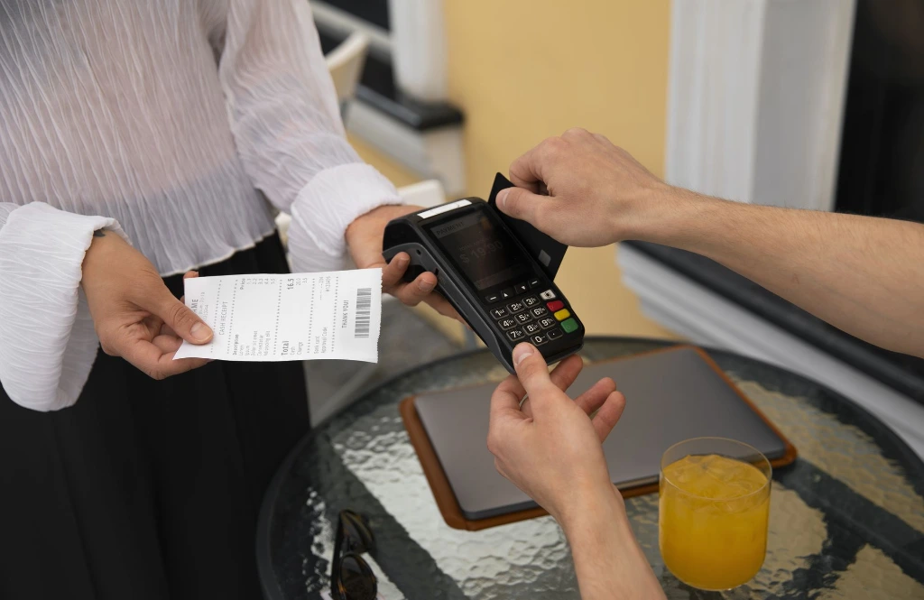 side-view-customer-paying-with-nfc-device(1).webp
